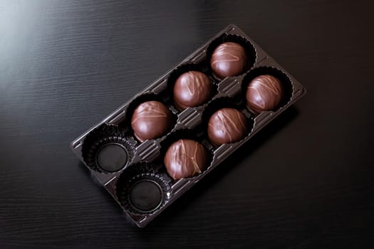 Chocolate candies in a box close up, macro photo