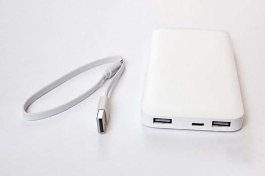 White power bank and cable on white background