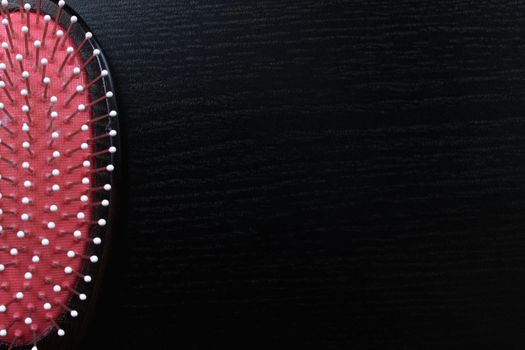 Wooden hairbrush on a wooden table closeup, copy space