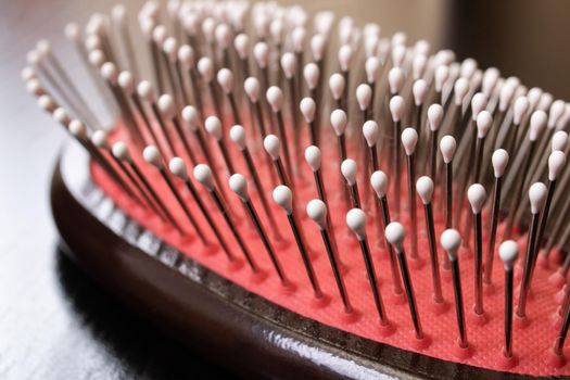 Wooden hairbrush on a wooden table close up