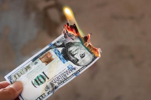 Burning 100 dollar bill close up, copy space