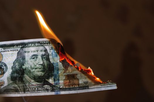 Burning 100 dollar bill close up, copy space