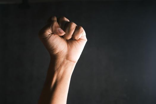 hands clenched power strength isolated on black