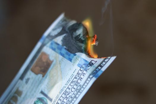 Burning 100 dollar bill close up, copy space