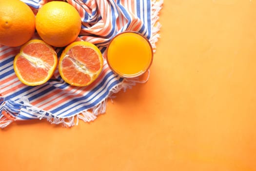 top view of orange juice and fruit on table .