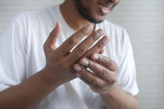 man suffering pain in hand close up .