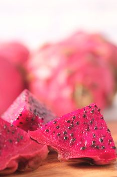 slice of dragon fruit on a chopping board.,