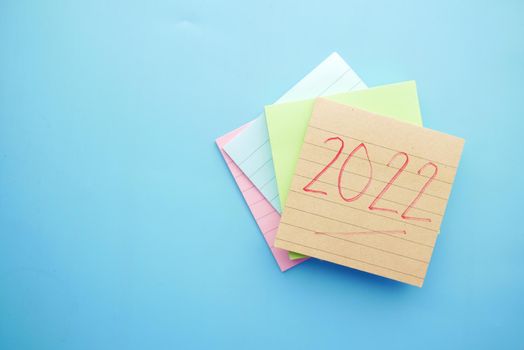 2022 new year goals on sticky notes on blue .