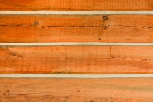 Wooden log wall texture background. Wall of a house built with timber bars