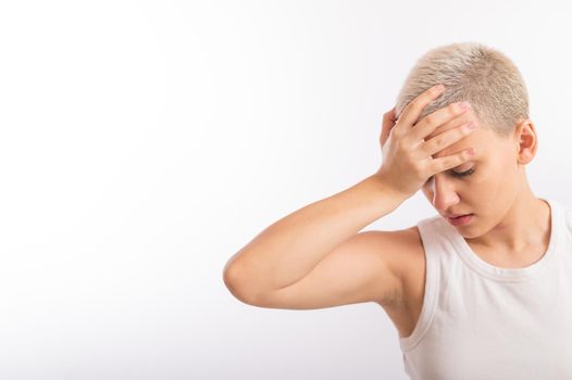 Young caucasian woman with short hair with a palm on her face on a white background