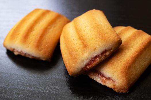Three square biscuit cookies on a wooden table