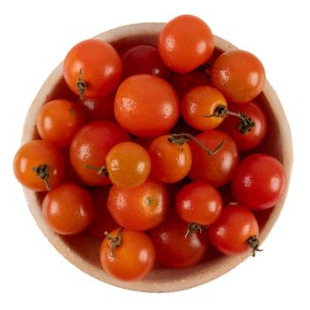 Fresh ripe cherry tomatoes in bowl isolated on white background, top view.