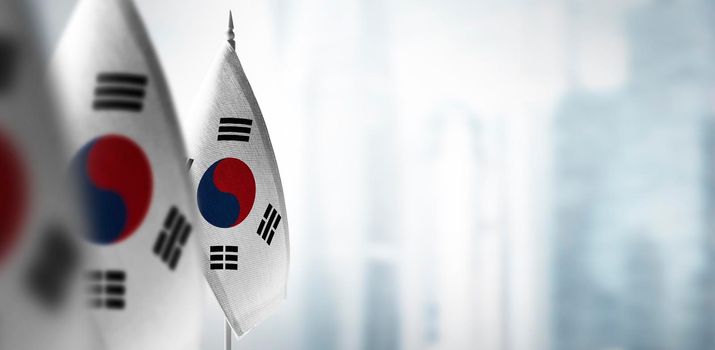Small flags of South Korean on a blurry background of the city.