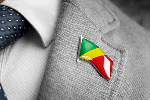 Metal badge with the flag of Congo on a suit lapel.