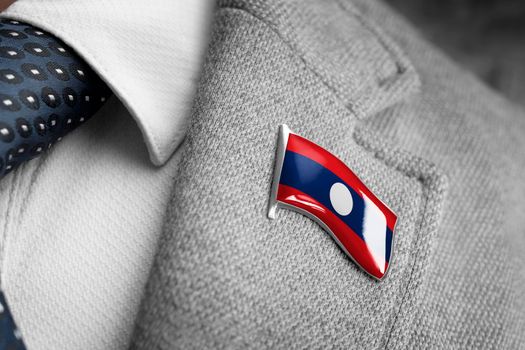 Metal badge with the flag of Laos on a suit lapel.