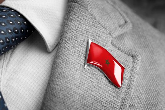 Metal badge with the flag of Morocco on a suit lapel.