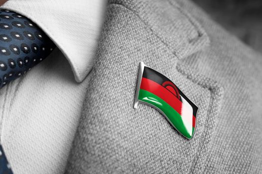 Metal badge with the flag of Malawi on a suit lapel.