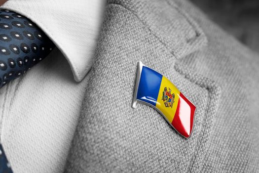 Metal badge with the flag of Moldavia on a suit lapel.