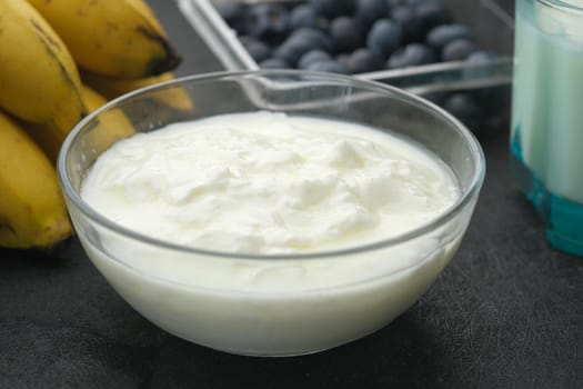 fresh yogurt in a bowl on table .