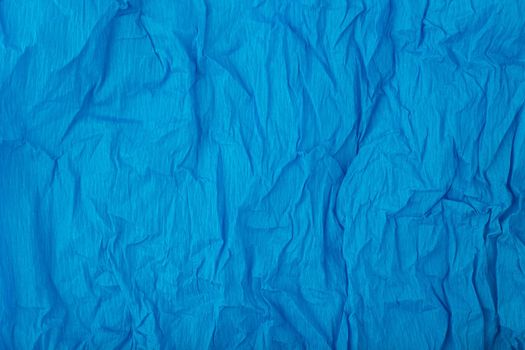 Blue crumpled paper texture background with space for text. Crumpled wrapping paper background. Concept of template for text with high resolution