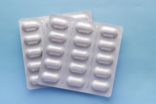 Close up of pills of blister pack on table .