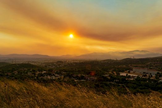 Athens view at sunset with red and yellow clouds from Penteli mountain. Greece.