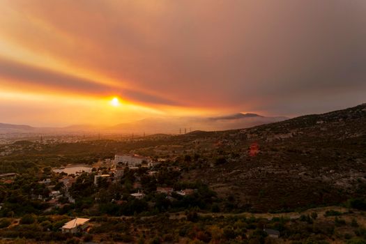 Athens view at sunset with red and yellow clouds from Penteli mountain. Greece.