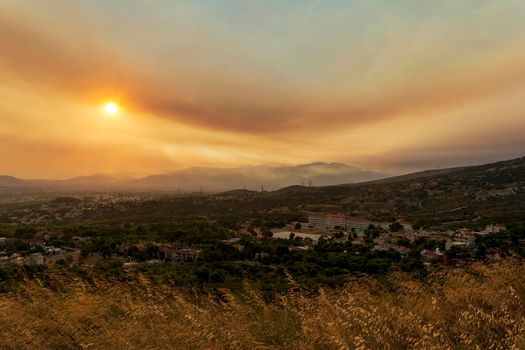 Athens view at sunset with red and yellow clouds from Penteli mountain. Greece.