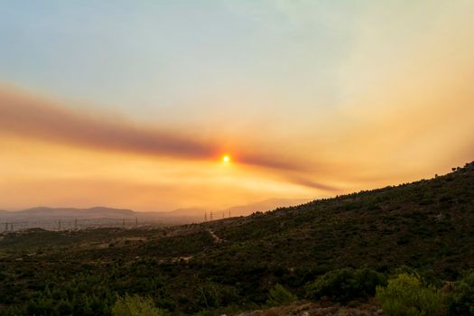 Athens view at sunset with red and yellow clouds from Penteli mountain. Greece.