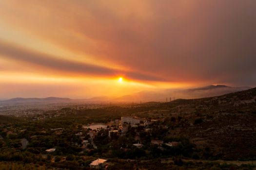 Athens view at sunset with red and yellow clouds from Penteli mountain. Greece.