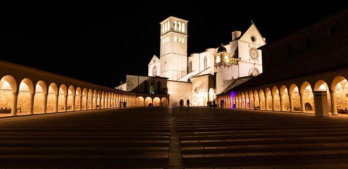 Assisi Basilica by night in Umbria region, Italy. The town is famous for the most important Italian St. Francis Basilica (Basilica di San Francesco)