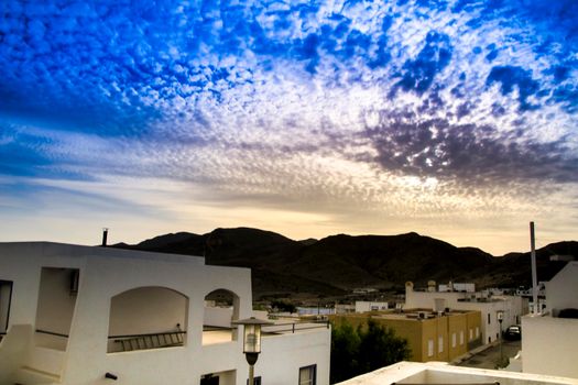 Landscape with Altocumulus floccus sky at sunset in Pozo de los Frailes village in Almeria, Spain