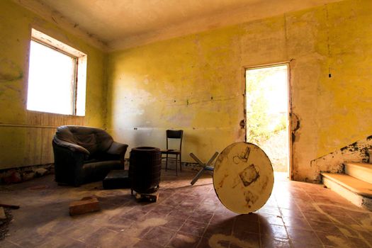Abandoned house with broken furniture in the gold mines of Rodalquilar village in Almeria province, Spain.