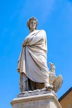 Dante Alighieri statue in Florence, Tuscany region, Italy, with an amazing blue sky background.