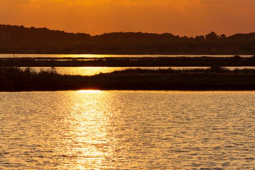 Sunset at the gialova lagoon. The gialova lagoon is one of the most important wetlands in Europe, as it constitutes the southernmost migratory station of migratory birds in the Balkans to and from Africa.