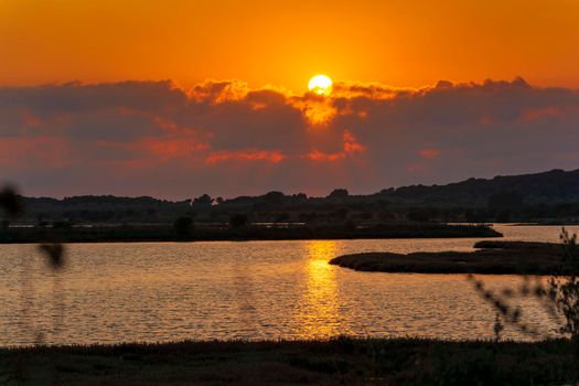 Sunset at the gialova lagoon. The gialova lagoon is one of the most important wetlands in Europe, as it constitutes the southernmost migratory station of migratory birds in the Balkans to and from Africa.