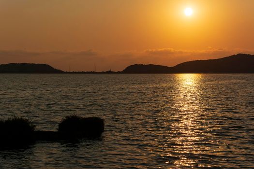 Sunset at the gialova lagoon. The gialova lagoon is one of the most important wetlands in Europe, as it constitutes the southernmost migratory station of migratory birds in the Balkans to and from Africa.