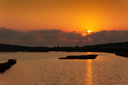 Sunset at the gialova lagoon. The gialova lagoon is one of the most important wetlands in Europe, as it constitutes the southernmost migratory station of migratory birds in the Balkans to and from Africa.