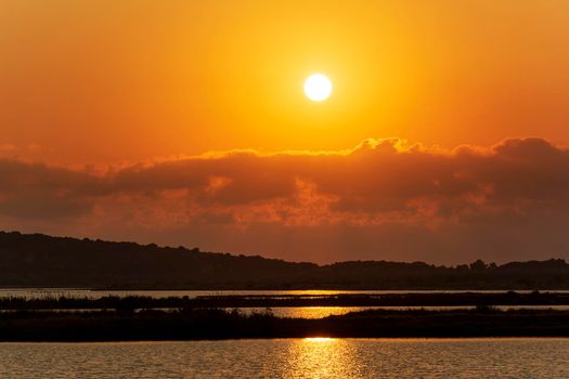 Sunset at the gialova lagoon. The gialova lagoon is one of the most important wetlands in Europe, as it constitutes the southernmost migratory station of migratory birds in the Balkans to and from Africa.