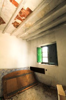 Green wooden window of old abandoned house in Spain.