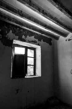 Wooden window of old abandoned house in Spain. Monochrome picture