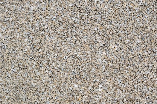 Dry white limestone ballast flat full frame background. Small gray dusty broken macadam stones texture. Viiew from above.