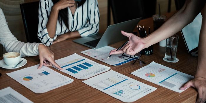 Group of business people discuss current financial and economic paperwork for investment at the meeting. Analytics intelligence concept