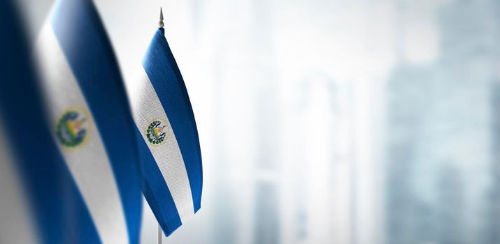 Small flags of Salvador on a blurry background of the city.