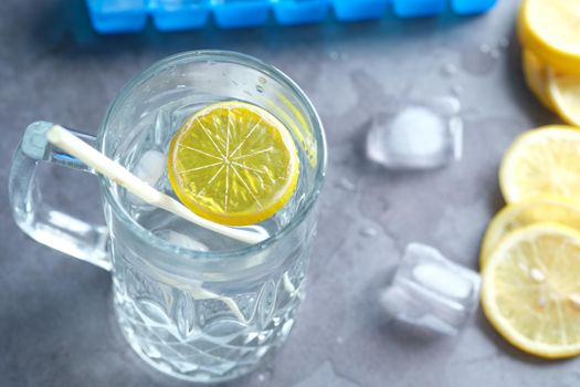 Refreshing lemon water drink on table , top view .