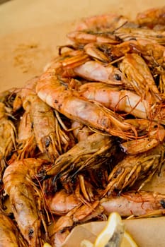 Large grilled shrimp on the counter. Street food festival. Selective focus. Close-up.