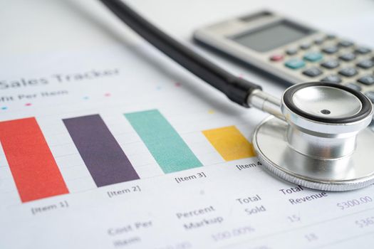 Stethoscope with calculator on chart graph paper, finance, account, statistic, analytic economy Business concept.