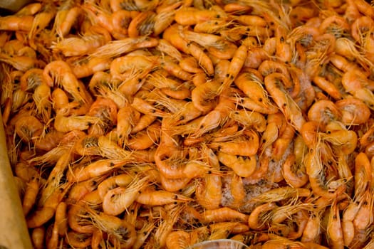 Small fresh boiled pink shrimp ready to eat. Street food festival. Selective focus. Close-up. Food background.