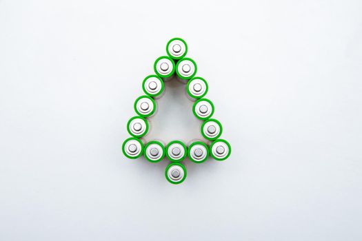 The batteries are in the shape of a Christmas tree on a white background. top view, flat lay, copy space, isolate. High quality photo