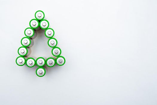 The batteries are in the shape of a Christmas tree on a white background. top view, flat lay, copy space, isolate. High quality photo